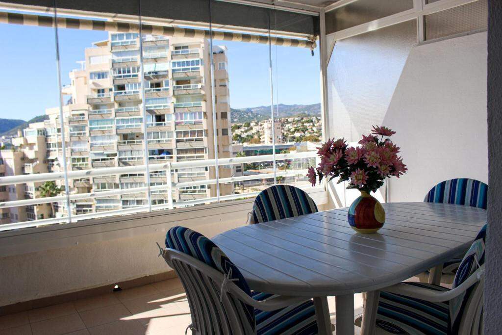 Apartment terrace with table and chairs overlooking Calpe